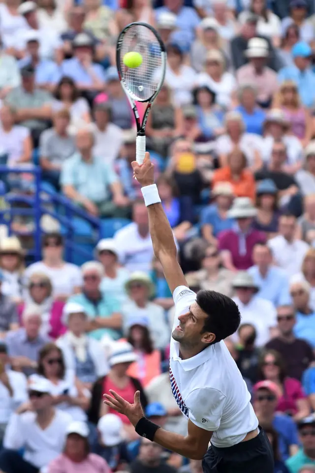 Novak Djokovic serves