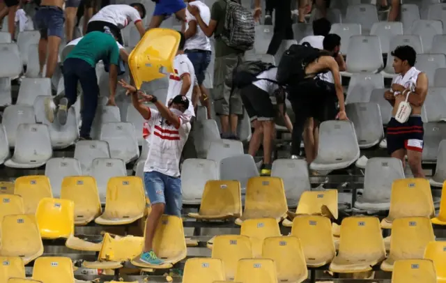 Zamalek throw seats and stones towards police at the end of the game.