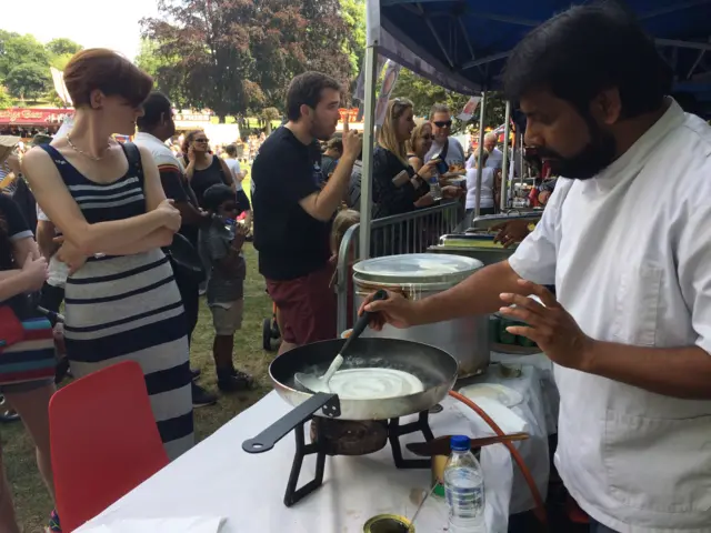 People waiting at cookery stall