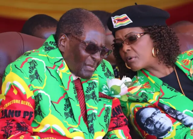 Zimbabwean President Robert Mugabe speaks with his wife Grace during a rally in Marondera, Zimbabwe, June 2, 2017.