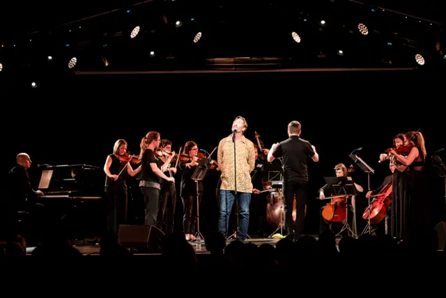 Performers standing on stage