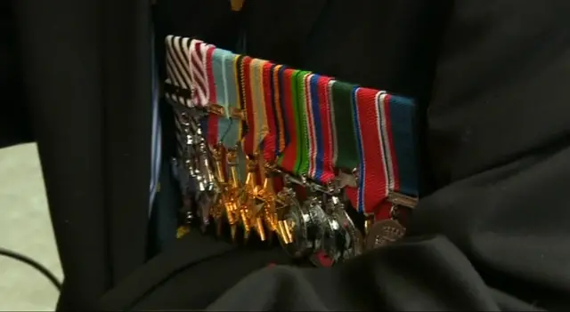 A row of medals on Tom Neil's chest