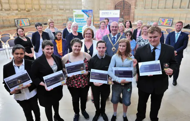 Young people holding certificates