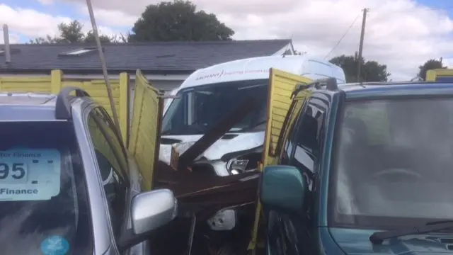 Van crashed through a fence.