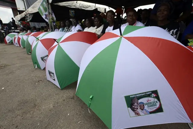 Branded umbrellas and with symbols of the ruling Peoples Democratic Party (PDP) are displayed with photographs of presidential candidate Goodluck Jonathan and running mate Namadi Sambo on March 24, 2015