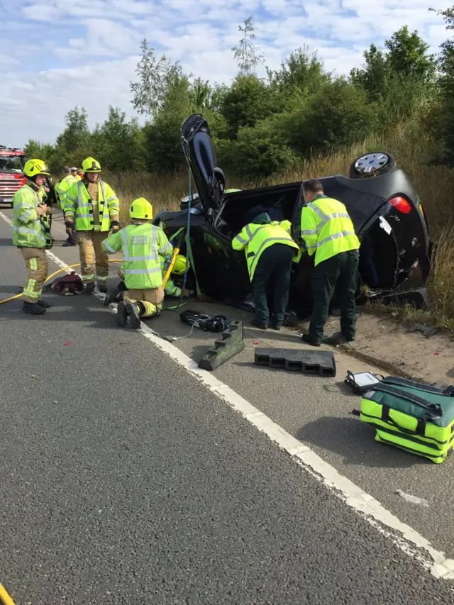 Emergency services helping after car overturned