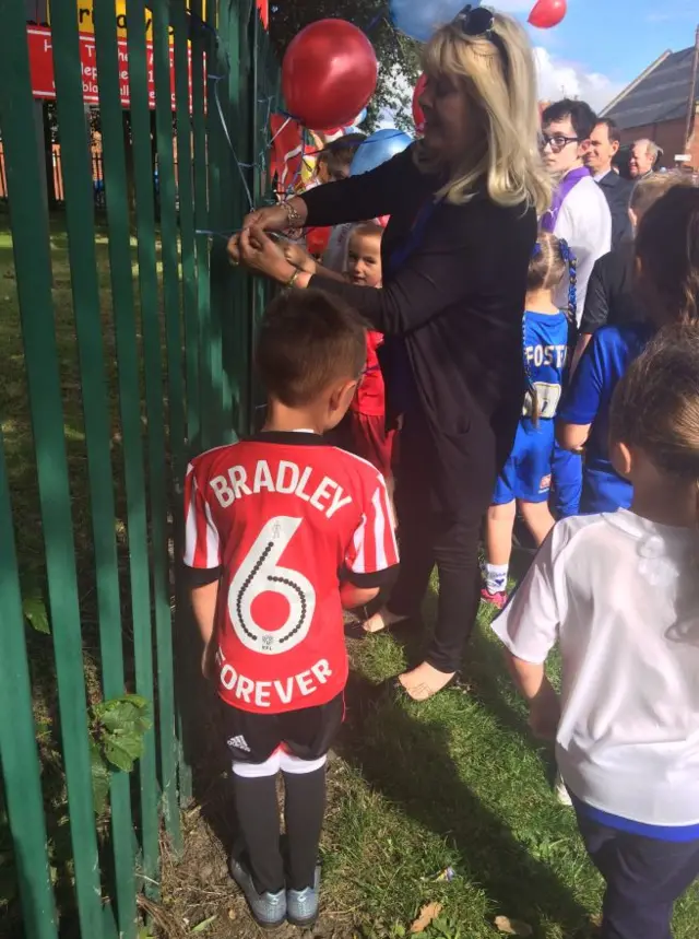 Teachers and pupils decorate the school gates