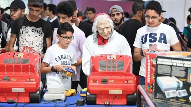 Tunisians play on a Super Nintendo console during the closing of the second edition of Comic Con Tunisia on July 9, 2017, in the town of Le Kram, north of Tunis