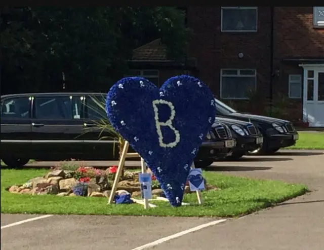 Floral tribute outside church