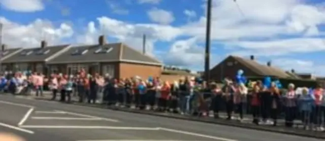 Mourners outside the church