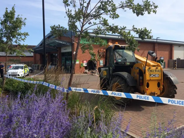 Police tape around scene of crime at supermarket