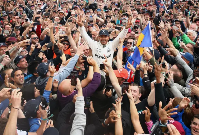 Lewis Hamilton celebrates winning the British GP