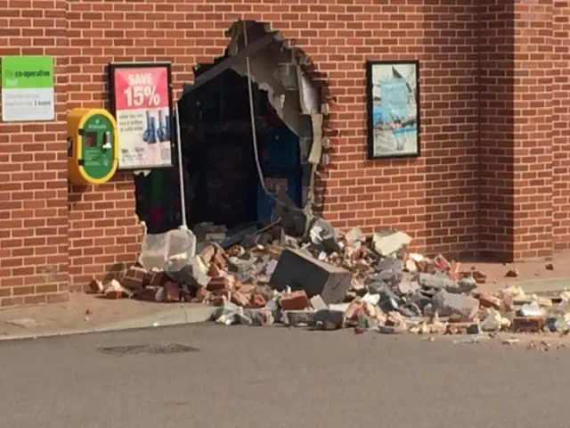 A gaping hole in the brick wall of supermarket, where the cash machine had been