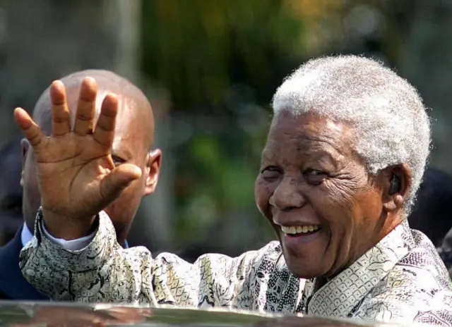 South Africa's former President Nelson Mandela waves to supporters on his arrival in Phoenix, south of Durban 06 April 2004.