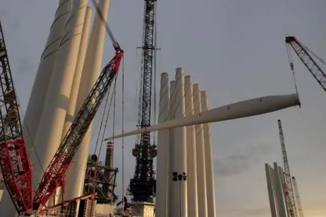 Wind Turbine blade being lowered onto the vessel taking it out to sea.