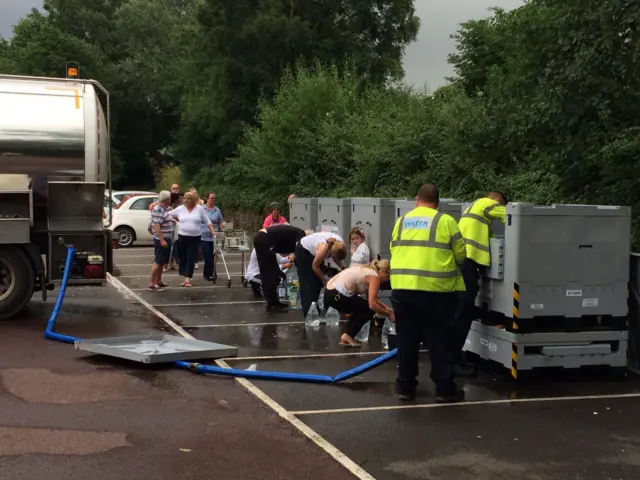 People queuing at a water bowser