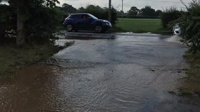 The flooded road after the burst this morning