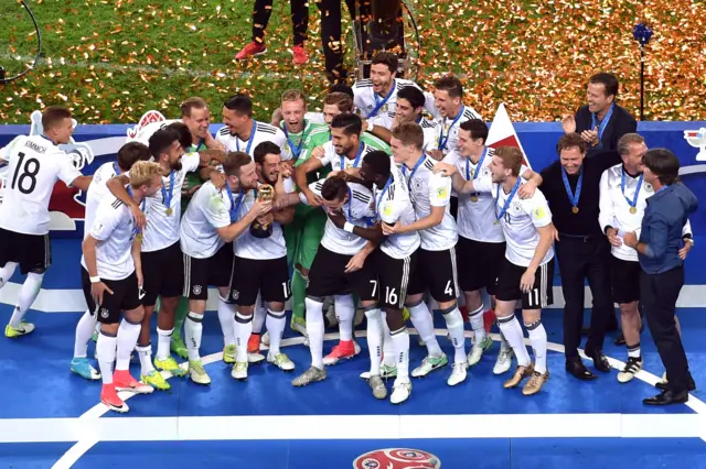 Germany's players lift the trophy