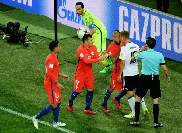 Arturo Vidal of Chile and Joshua Kimmich of Germany confront each other