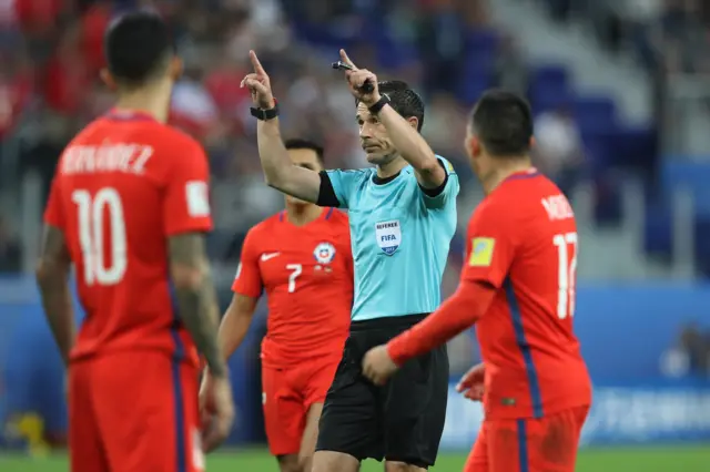 Referee Milorad Mazreacts gestures for the video referee