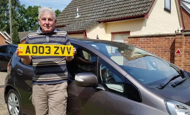 Brian Moore holding his registration plate