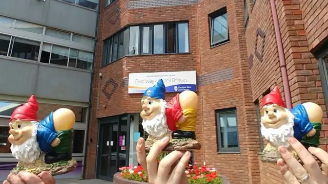 Gnomes being held up outside council offices