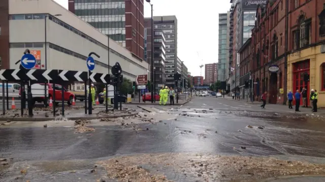 Water gushing onto road at West Bar