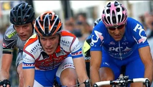 Three cyclists racing.