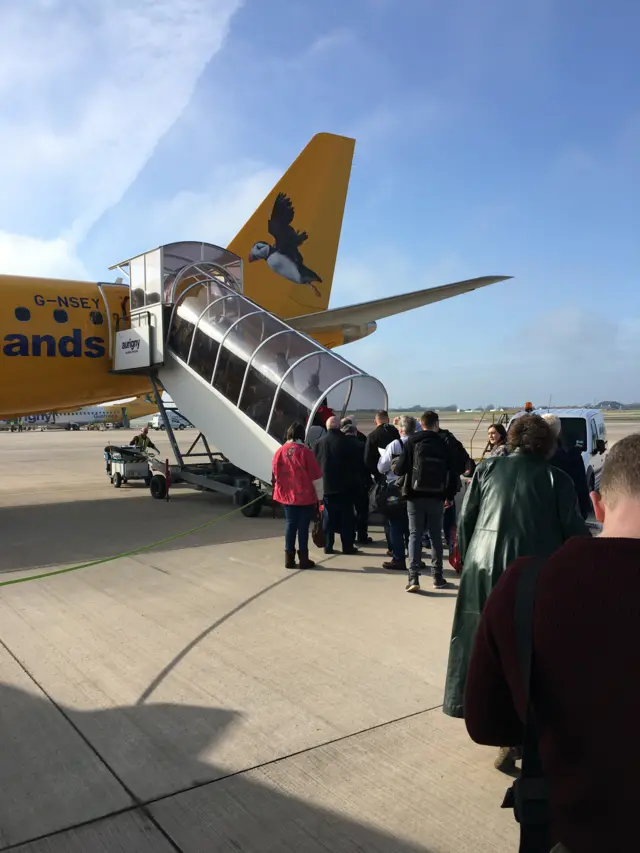 Passengers getting on the Aurigny jet