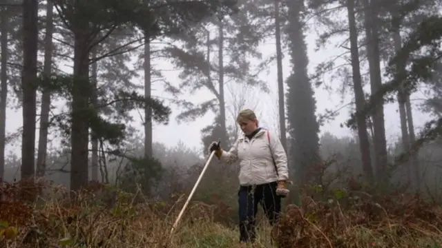 Nicola Urqhart searching undergrowth