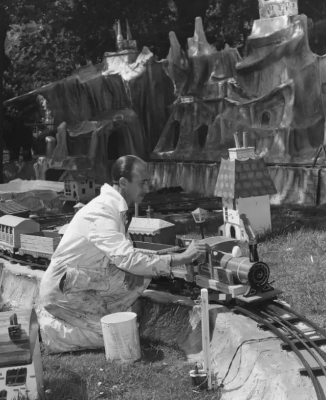 July 1964: Joe Page at work painting a toy train in a fairyland setting in the Shrubbery at Southend-on-Sea in preparation for the switch-on at the end of July