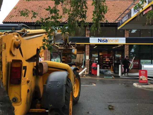 The forklift in front of the Nisa store