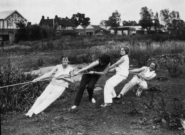 Black and white photo of the four women hauling in their boat