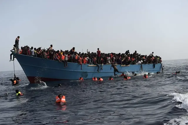 Migrants wait to be rescued by members of Proactiva Open Arms NGO in the Mediterranean Sea, some 12 nautical miles north of Libya, on October 4, 2016.