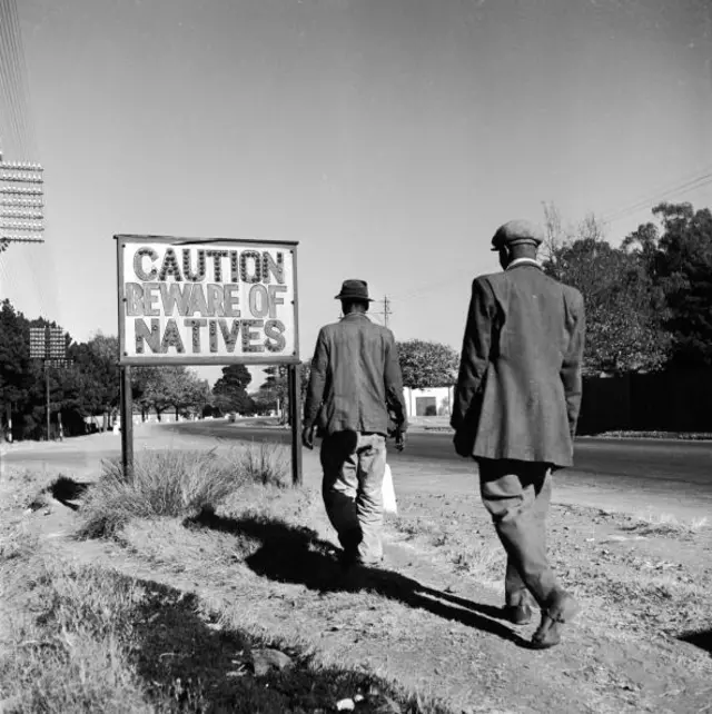 A sign common in Johannesburg, South Africa, reading 'Caution Beware Of Natives'.