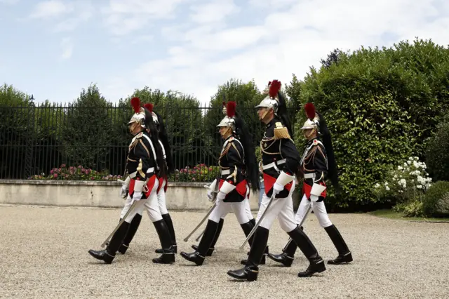 The Republican Guard takes position prior to the arrival of French President Emmanuel Macron at the castle of La Celle Saint Cloud, west of Paris, France, 25 July 2015.