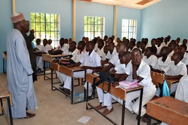 Students of government college listen to a lecture in a classroom following the re-opening ceremony of public schools in Maiduguri, northeast Nigeria, on October 10, 2016.