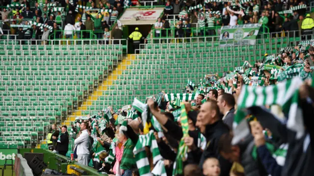 Celtic supporters, minus the Green Brigade, cheer on their side ahead of kick-off