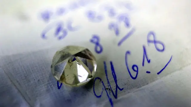 A diamond sits on its polishing instructions October 31, 2002 in Antwerp, Belgium.