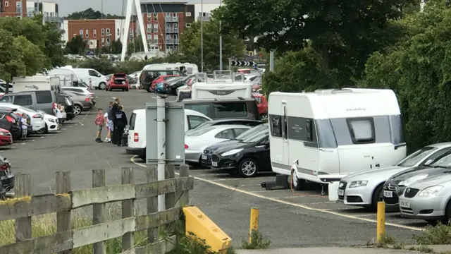 Travellers in car park