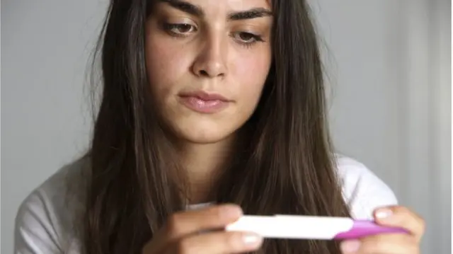 Teenager checking pregnancy test