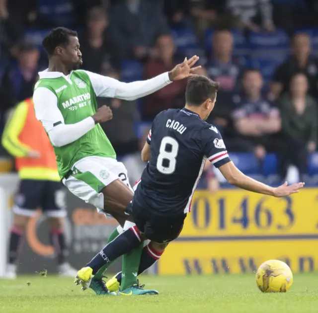 Hibs' Efe Ambrose is tackled by Ross County's Tim Chow