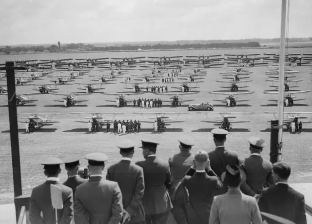 Eighty two years ago this month, a picture was taken of a fleet of aircraft arrayed over a field during the RAF Jubilee Review at Mildenhall, Suffolk.