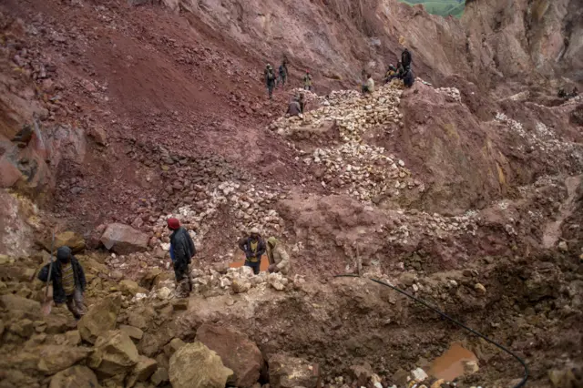 Artisanal miners work at a cassiterite mining site near Numbi in eastern Democratic Republic of Congo