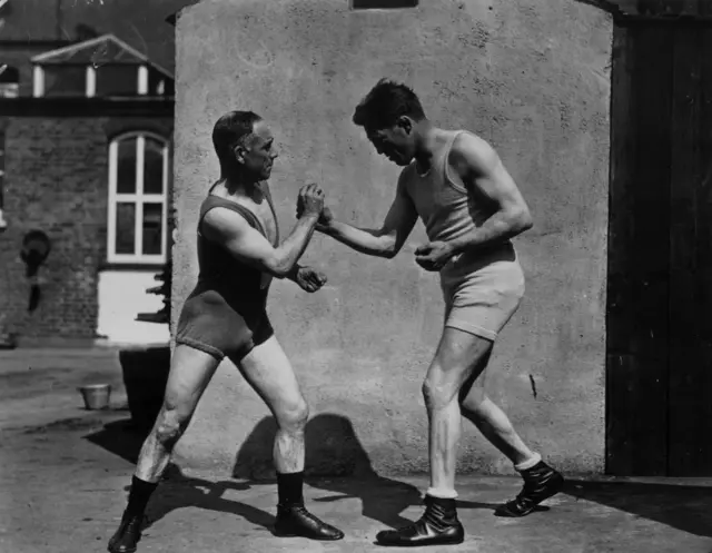 Boxer, Ted "Kid" Lewis (born Gershon Mendeloff) spars with Thomas "Pedlar" Palmer