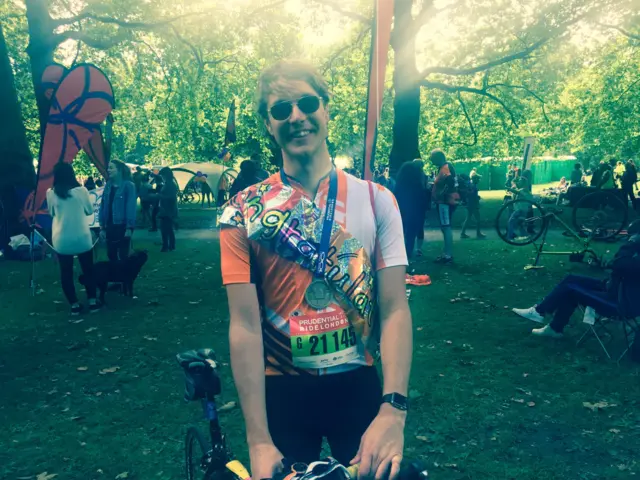 RideLondon finisher wearing a congratulations banner from his girlfriend