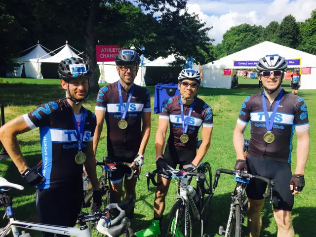 Kay, James, Frank and Richard from TVS cycling club holding up their RideLondon medals