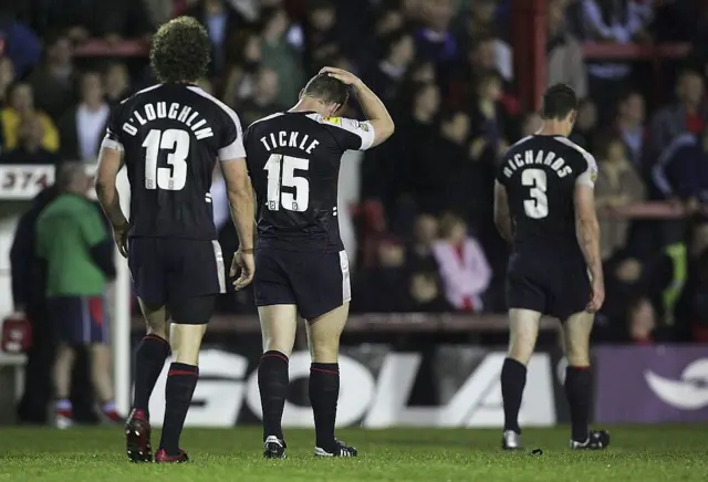 Wigan's players look disappointed after Challenge Cup defeat by Salford