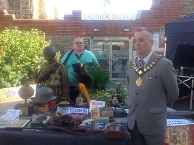 John Frosdick, in mayoral chain, standing at display stand outside museum