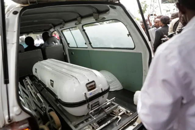 Mortuary attendant stands next to the casket with body of Chris Musando, an IT manager at the Kenyan Independent Electoral and Boundaries Commission (IEBC), at city mortuary, in Nairobi, Kenya, 31 July 2017.